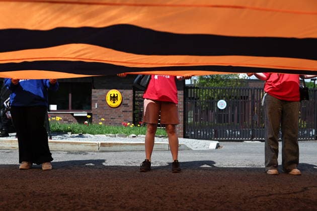 RUSSIA, MOSCOW - MAY 7, 2026: People unfurl a giant St George ribbon during an event titled You Cannot Cancel Truth and Memory! outside the German Embassy in Moscow. Sofya Sandurskaya TASS  92136523