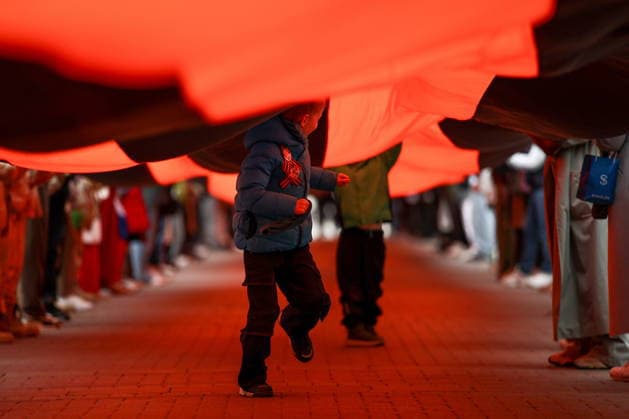 RUSSIA, MOSCOW - MAY 9, 2026: People unfurl a giant St George ribbon during a flash mob on Arbat Street on Victory Day. Mikhail Tereshchenko TASS  92238507