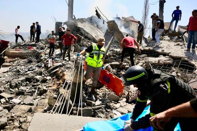 (260510) -- SAKSAKIYEH, May 10, 2026 -- Rescuers search for victims amid the rubble of a residential building after Israeli airstrikes in Saksakiyeh, south Lebanon, May 9, 2026. At least 15 people were killed in a series of Israeli airstrikes in southern Lebanon on Saturday, according to Lebanese official sources. At least one child was among those killed and several children were among those injured in the strikes, according to the Lebanese Health Ministry and the National News Agency. (Photo by Xinhua) LEBANON-SAKSAKIYEH-ISRAELI AIRSTRIKE-AFTERMATH AlixHashisho 