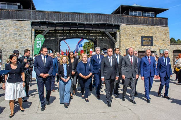 mauthausen, austria, 10 may 2026, members of the austrian givernment walking through the gate at the 81th anniversary of liberation ceremony at the concentration camp