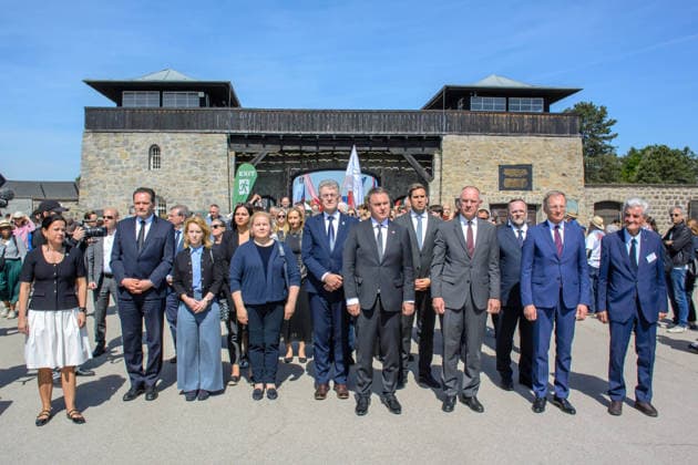 mauthausen, austria, 10 may 2026, members of the austrian givernment walking through the gate at the 81th anniversary of liberation ceremony at the concentration camp