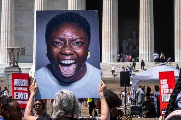 May 10, 2026, Washington, Dc, USA: A protester holds a sign in front of the Lincoln Memorial for the Black Mothers March, where dozens gathered to demand greater protection for Black mothers and families on MotherÃ¢â‚¬â ¢s Day. Washington USA - ZUMAh204 20260510_znp_h204_004 Copyright: xRileyxHartyx