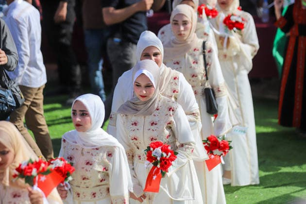 Mass Wedding Gaza City May 11 Brides holding bouquets walk in a procession during a mass wedding celebration in Gaza City, Gaza Strip, on May 11, 2026. The mass wedding celebration for 50 grooms, identified by organizers as orphans of conflict casualties, is sponsored by the Turkish Humanitarian Relief Foundation (IHH). Gaza Gaza Strip Palestinian Territories Copyright: xAhmedxAlxArinix