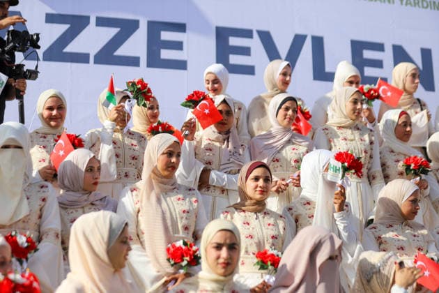 Mass Wedding Gaza City May 11 Brides holding bouquets gather on the steps of a stage during a mass wedding celebration in Gaza City, Gaza Strip, on May 11, 2026. The mass wedding celebration for 50 grooms, identified by organizers as orphans of conflict casualties, is sponsored by the Turkish Humanitarian Relief Foundation (IHH). Gaza Gaza Strip Palestinian Territories Copyright: xAhmedxAlxArinix