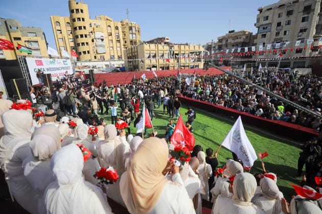 Mass Wedding Gaza City May 11 Brides hold bouquets as they face a crowd of guests and a separate stage of grooms during a mass wedding celebration in Gaza City, Gaza Strip, on May 11, 2026. The mass wedding celebration for 50 grooms, identified by organizers as orphans of conflict casualties, is sponsored by the Turkish Humanitarian Relief Foundation (IHH). Gaza Gaza Strip Palestinian Territories Copyright: xAhmedxAlxArinix
