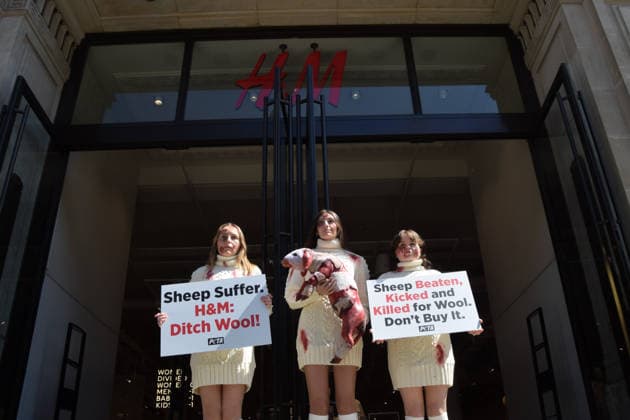 May 12, 2026, London, England, United Kingdom: PETA activists with fake bruises and blood hold a fake dead lamb during a protest outside H&M on Regent Street, calling on the fashion group to stop selling wool. London United Kingdom  - ZUMAv130 20260512_zip_v130_006 Copyright: xVukxValcicx