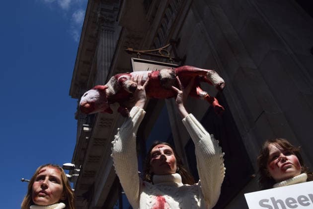 May 12, 2026, London, England, United Kingdom: PETA activists with fake bruises and blood hold a fake dead lamb during a protest outside H&M on Regent Street, calling on the fashion group to stop selling wool. London United Kingdom  - ZUMAv130 20260512_zip_v130_009 Copyright: xVukxValcicx