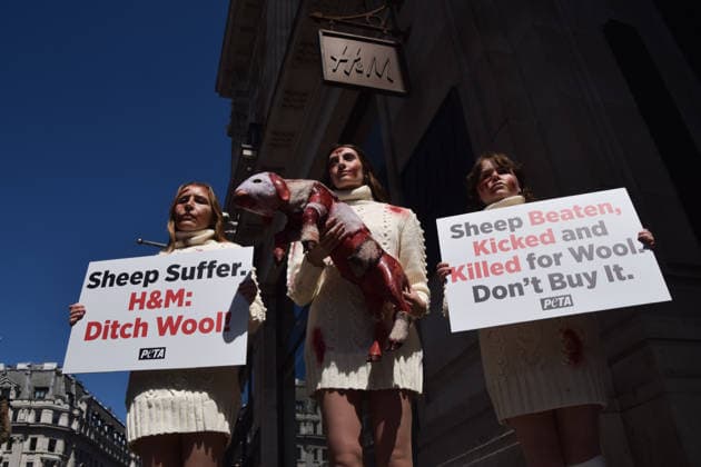May 12, 2026, London, England, United Kingdom: PETA activists with fake bruises and blood hold a fake dead lamb during a protest outside H&M on Regent Street, calling on the fashion group to stop selling wool. London United Kingdom - ZUMAv130 20260512_zip_v130_008 Copyright: xVukxValcicx