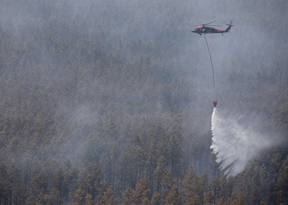 May 12, 2026, Pineland, Ga, United States of America: A U.S. Army UH-60 Black Hawk helicopter with the Georgia Army National Guard, drops water from a Bambi Bucket during the wildfire suppression efforts, April 28, 2026 in Pineland, Georgia. The Pineland Road Wildfire has burned at least 32,000 acres and destroyed over 100 homes across southern Georgia. Pineland United States of America - ZUMAp138 20260512_zaa_p138_048 Copyright: xSgt.xJordanxMcneal UsxArmyx