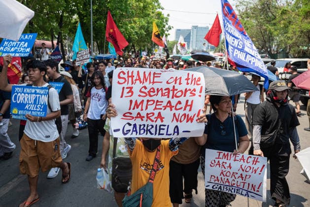 May 13, 2026, Pasay, Metro Manila, Philippines: A protester holds up a sign condemning the 13 senators who voted not to impeach the vice president. Pasay Philippines - ZUMAy102 20260513_zip_y102_024 Copyright: xKenosisxYapx