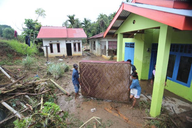Aftermath of flood in Sumatra TANAH DATAR, INDONESIA - MAY 13: Residents wade through while carrying their stuff to safety after heavy rain in Tanah Datar, West Sumatera Province, Indonesia on May 13, 2026. The structures affected by the floods include residential homes, vehicle, irrigation dam, two village bridge, subdistrict roads, and the rice field. Adi Prima Anadolu Tanah Datar Indonesia. Editorial use only. Please get in touch for any other usage.  Copyright: x2026xAnadoluxAdixPrimax