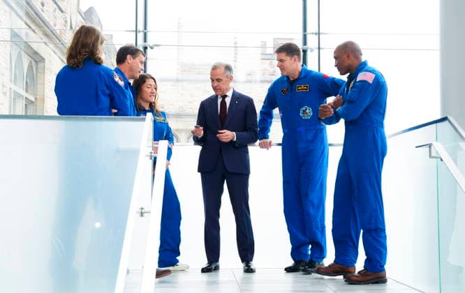 May 13, 2026, Ottawa, On, Canada: Prime Minister Mark Carney, centre, is presented with a Artemis Challenge Coin from astronauts of the Artemis II mission, Artemis Capsule Communicator Jenni Gibbons, left to right, Commander Reid Wiseman, Mission Specialist Christina Koch, Mission Specialist Jeremy Hansen, and Pilot Victor Glover, as they arrive to visit with students at the Museum of Nature in Ottawa on Wednesday, May 13, 2026. Ottawa Canada  - ZUMAc35_ 20260513_zaf_c35_034 Copyright: xSeanxKilpatrickx