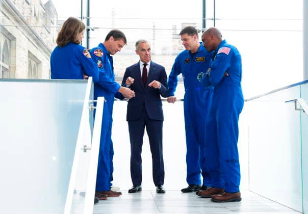 May 13, 2026, Ottawa, On, Canada: Prime Minister Mark Carney, middle, is presented with a Artemis Challenge Coin from astronauts of the Artemis II mission, Artemis Capsule Communicator Jenni Gibbons, left to right, Commander Reid Wiseman, Mission Specialist Christina Koch (hidden), Mission Specialist Jeremy Hansen, and Pilot Victor Glover, as they arrive to visit with students at the Museum of Nature in Ottawa on Wednesday, May 13, 2026. Ottawa Canada  - ZUMAc35_ 20260513_zaf_c35_035 Copyright: xSeanxKilpatrickx
