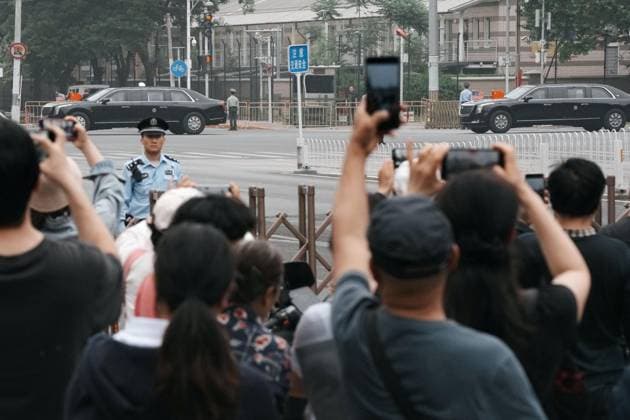 U.S. President Trump in Beijing People hold up their smartphones as a car believed to be carrying U.S. President Donald Trump drives through Beijing on May 15, 2026, the second day of summit talks between him and Chinese President Xi Jinping.  A14AA0005560435P