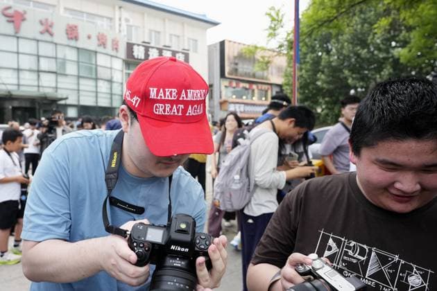U.S. President Trump departs Beijing A man wearing a cap with U.S. President Donald Trump s slogan Make America Great Again checks a photo he took of Air Force One carrying the president taking off from an airport in Beijing on May 15, 2026, following his state visit to China for a summit with Chinese President Xi Jinping.  A14AA0005560839P