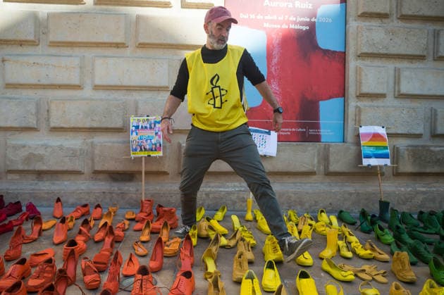 Protest against violence against LGBT people in Malaga - 15 May 2026 A member of Amnesty International is seen walking between colorful shoes placed on the ground as he takes part in a protest to mark the International Day Against Homophobia, Biphobia and Transphobia (IDAHOBIT), which is celebrated on 17 May. Amnesty International and the local NGO Ojalá have placed hundreds of colourful shoes representing the LGBT+ pride flag as part of an artistic performance that denounces violence against LGBT+ people around the world. Malaga Spain Copyright: xJesusxMeridax xSOPAxImagesx 15052026_JMERIDA2-19