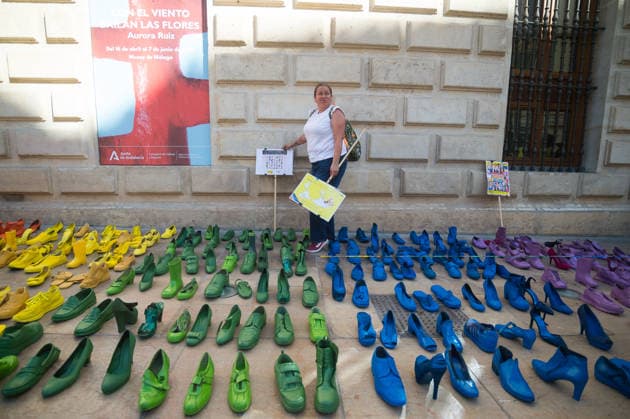 May 15, 2026, Malaga, Spain: A woman is seen holding placards and walking between colorful shoes placed on the ground as she takes part in a protest to mark the International Day Against Homophobia, Biphobia and Transphobia (IDAHOBIT), which is celebrated on 17 May. Amnesty International and the local NGO Ojala have placed hundreds of colourful shoes representing the LGBT+ pride flag as part of an artistic performance that denounces violence against LGBT+ people around the world. Malaga Spain - ZUMAs197 20260515_aaa_s197_452 Copyright: xJesusxMeridax