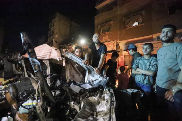 Destroyed Car Al-Nasr Street Gaza City People stand next to the wreckage of a vehicle, targeted on Al-Nasr Street in Gaza City, Gaza Strip, on May 16, 2026. Gaza Gaza Strip Palestinian Territories Copyright: xAhmedxAlxArinix