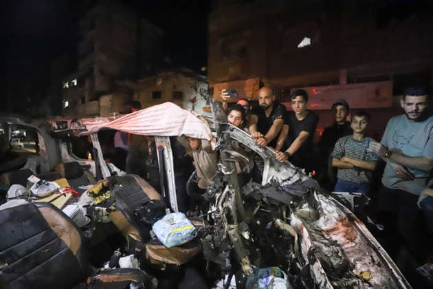 Destroyed Car Al-Nasr Street Gaza City People stand next to the wreckage of a vehicle, targeted on Al-Nasr Street in Gaza City, Gaza Strip, on May 16, 2026. Gaza Gaza Strip Palestinian Territories Copyright: xAhmedxAlxArinix