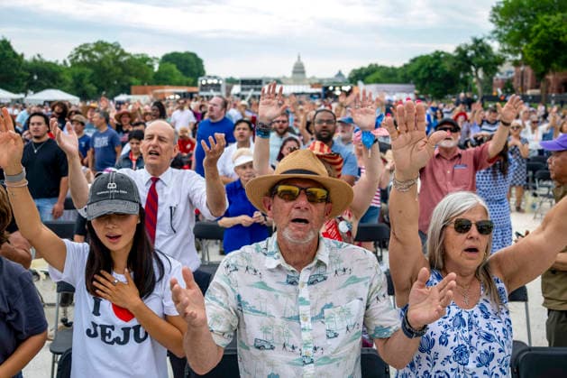 People worship during Rededicate 250 on the National Mall in Washington, DC on Sunday, May 17, 2026. The event, organized by Freedom 250 and the White House Faith Office, will feature political and faith leaders honoring 250 years of American history and encourage prayer or the country s next 250 years.  WAP20260517326 BONNIExCASH