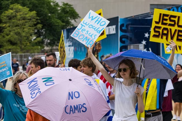 May 17, 2026, Washington, District Of Columbia, USA: A young woman holds a sign reading Ã¢â‚¬oeWho would Jesus bomb?Ã¢â‚¬Â outside the Ã¢â‚¬oeRededicate 250Ã¢â‚¬Â event on the National Mall Washington USA  - ZUMAh196 20260517_znp_h196_020 Copyright: xTomxHudsonx