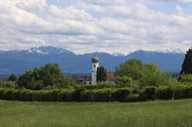 Ein Frühsommertag bei Tutzing (Landkreis Starnberg). Hier der Blick von der Ilkahöhe auf den Kirchturm des Nikolauskircherl, im Hintergrund die Benediktenwand und rechts das Karwendel ,wandern, spazieren, Radfahren, Ausblick, Naherholung, Münchner Umland, Wetterbild, Ausflugswetter