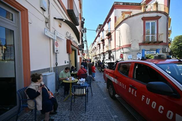 Foto IPP Felice De Martino Bacoli - Napoli - 21 05 2026 Scossa di terremoto nella zona dei Campi Flegrei nella foto alcune persone seduto ai tovolini di un locale mentre i vigili del fuoco controllano i danni ad un edificio in via Ercole - Italy Photo Press - World Copyrigh -