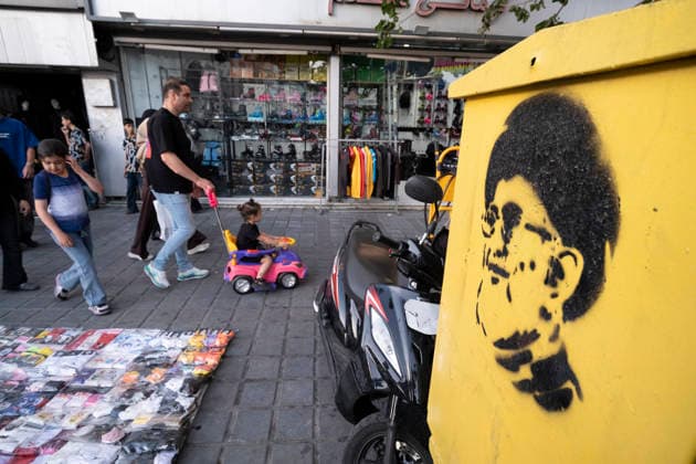 Daily Life In Iran Amid Threat About New Possible War An Iranian family walks past graffiti depicting a portrait of Iran s late Supreme Leader Ayatollah Ali Khamenei in a business district in downtown Tehran, Iran, on May 22, 2026. U.S. President Donald Trump has threatened Iran with the possibility of a new conflict, and according to official reports, he is considering military action if no agreement is reached with Iranian officials. Tehran Tehran Iran  Copyright: xMortezaxNikoubazlx originalFilename: nikoubazl-dailylif260522_npiRF