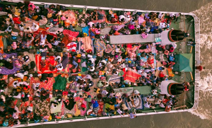 May 26, 2026, Dhaka, Munshiganj, Bangladesh: MUNSHIGANJ, BANGLADESH †MAY 2026: An aerial top-down view captured from the Mukterpur Bridge in Munshiganj shows overcrowded passenger ferries (locally known as launches) traveling along the river, packed with thousands of home-bound people leaving Dhaka s Sadarghat terminal. Every year, ahead of the Muslim festival of Eid-ul-Adha, millions of people working in the capital city Dhaka endure hectic journeys and brave overcrowded public transport to return to their ancestral villages and celebrate the festival with their families. Many passengers who fail to secure indoor cabins opt to spend the hours-long journey on the open top decks, layout out colorful blankets, mats, and sheets to rest - ZUMAa259 20260526_zip_a259_005 Copyright: xRayhanxAhmedx
