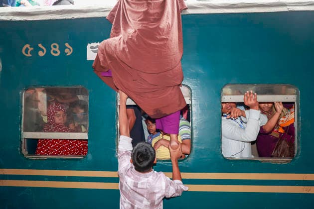 May 26, 2026, Tongi, Bangladesh: Bangladeshi Muslim passengers struggle to board an overcrowded train as they travel home ahead of the upcoming Eid al-Adha festival at a railway station in Tongi, near Dhaka, Bangladesh, Monday, May 26, 2024. Millions of people are expected to leave the capital in one of the countryÃ¢â‚¬â ¢s largest annual holiday exoduses to celebrate Eid with their families in rural areas. Tongi Bangladesh  - ZUMAd117 20260526_fap_d117_038 Copyright: xSuvraxKantixDasx