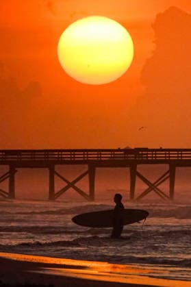 May 27, 2026, Isle Of Palms, Sc, United States: A surfer silhouetted by the sunrise on a hazy hot morning along Front Beach, May 27, 2026 in Isle of Palms, South Carolina. Temperatures in the low country region are in the low 90Ã¢â‚¬â ¢s Isle Of Palms United States  - ZUMAe02_ 20260527_zaf_e02_001 Copyright: xRichardxEllisx