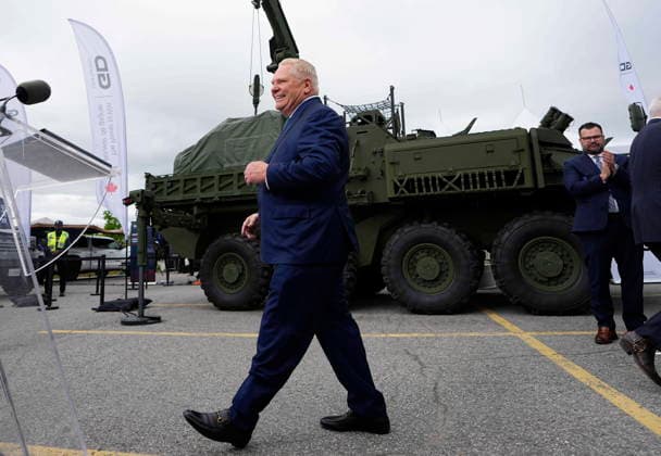 May 28, 2026, Ottawa, On, Canada: Premier of Ontario Doug Ford walks past a General Dynamics Land Systems-Canada (GDLS-C) Armoured Combat Support Vehicle (ACSV), as he heads the lectern at a news conference at the Canadian Association of Defence and Security Industries annual defence industry trade show CANSEC, in Ottawa, on Thursday, May 28, 2026. Ottawa Canada  - ZUMAc35_ 20260528_zaf_c35_009 Copyright: xJustinxTangx