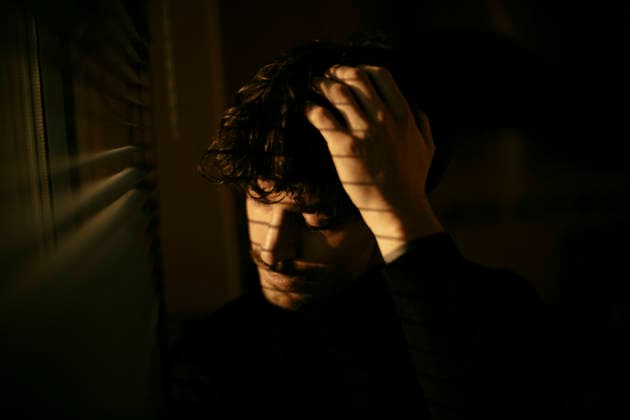 Man displaying deep mental stress and contemplation indoors model released, Symbolfoto, GMLF01808
