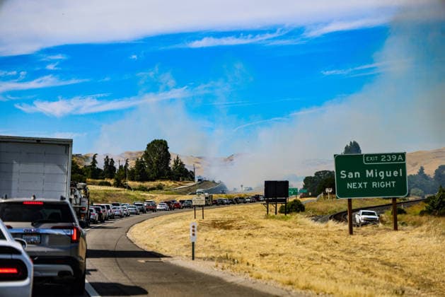 June 7, 2026, Ca, USA: San Miguel Next Right sign and smoke billowing behind it as a A brush fire broke out along Highway 101 and Cemetery Road near the historic San Miguel Mission in San Miguel, California, on the afternoon of June 7, 2026, after a four-vehicle crash. USA - ZUMAk144 20260607_znp_k144_021 Copyright: xAmyxKatzx