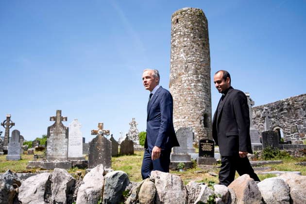 June 14, 2026, Aghagower, County Mayo, Ireland: Prime Minister Mark Carney walks in the St Patrick Church cemetary with Father Britus Kadavunkal Francis, in Aghagower, County Mayo, Ireland, on Sunday, June 14, 2026. Aghagower, County Mayo Ireland - ZUMAc35_ 20260614_zaf_c35_032 Copyright: xChristopherxKatsarovx