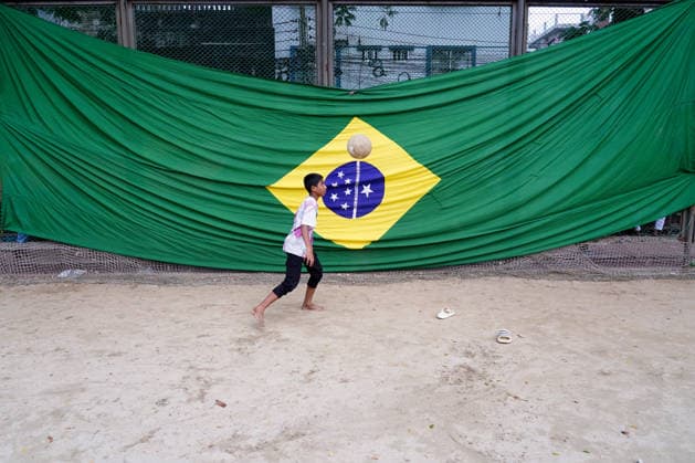 June 15, 2026, Dhaka, Dhaka, Bangladesh: Dhaka, Bangladesh †June 15, 2026 As FIFA World Cup fever sweeps across the globe, Bangladesh has also been caught up in the excitement. Football fans throughout the country are enthusiastically supporting their favorite teams, creating a festive atmosphere nationwide...Supporters are purchasing team jerseys, flags, and other memorabilia ahead of the tournament. Shops and street vendors are witnessing increased demand for World Cup-related merchandise, while roads, neighborhoods, and rooftops are decorated with colorful national flags representing competing nations...Children and teenagers have also joined the celebration, taking to streets and playgrounds with footballs in hand, inspired by t - ZUMAk185 20260615_zip_k185_058 Copyright: xRubelxKarmakerx