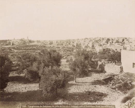 RECORD DATE NOT STATED General view of Bethlehem from David s well. - General view of Bethlehem from David s well., View of Bethlehem from David s Well, photograph, Part of Travel Album with Photos of Jerusalem and Other Biblical Places., negative number: 1225 , photographer: Maison Bonfils, Bethlehem (Israel), c. 1867 - c. 1895, Maison Bonfils, photographer, Palestine, pasteboard, paper, albumen print, height 224 mm x width 284 mm, prospect of village, silhouette of village, A wide panoramic scene showing a hillside landscape with scattered trees and terraced ground in the foreground and a dense cluster of flat-roofed stone buildings on a rise in the background, with a few larger structures that have towers or domes among the buildings; stone walls and paths ar Copyright Penta Springs LCK260531_18258