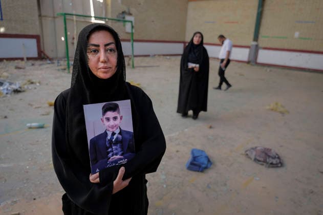 Iran Lamerd Sports Facility Missile Strikes Aftermath A woman holds a portrait of a child inside a damaged sports hall in Lamerd, Fars Province, Iran, on June 4, 2026. On February 28, 2026, a two-missile strike hit the facility while a women s volleyball team used it, killing at least 21 people and injuring around 100 others. Independent investigations concluded a United States Precision Strike Missile was used in the attack, though the United States Central Command denied responsibility. Lamerd Fars Iran Copyright: xLaurinxStrelex