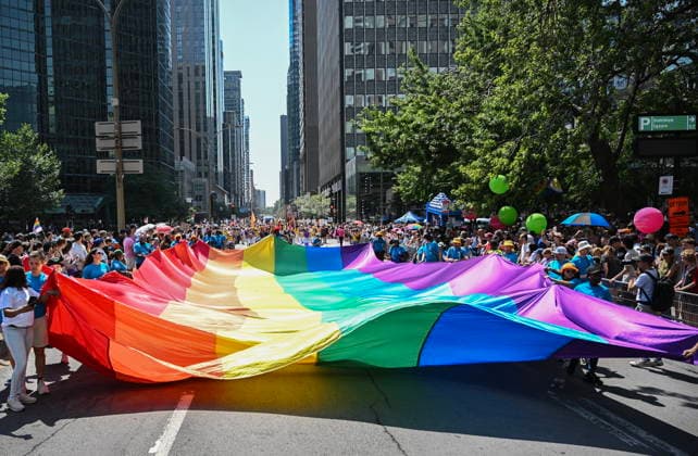 August 10, 2025, Montreal, Pq, Canada: Participants carry a rainbow flag along a street during the Pride parade in Montreal, Sunday, Aug. 10, 2025. Montreal Canada  - ZUMAc35_ 20250810_zaf_c35_025 Copyright: xGrahamxHughesx