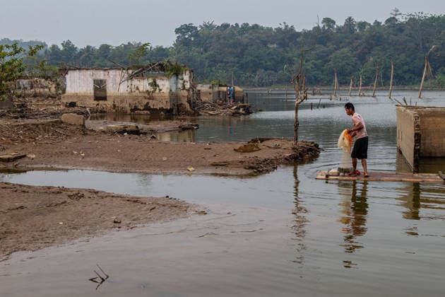 July 31, 2026, Lebak Regency, Banten, Indonesia: A man casts a fishing net from a bamboo raft as he navigates the ruins of Somang village, which has re-emerged as water levels recede during the dry season, amid forecasts that El Nio±o may contribute to drier-than-normal conditions, at Karian Reservoir in Sajira district, Lebak Regency, Banten province, Indonesia, July 31, 2026. Lebak Regency Indonesia - ZUMAp283 20260731_zip_p283_021 Copyright: xClaudioxPramanax