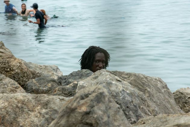July 31, 2026, Ceuta, Ceuta, Spain: Migrants sit on rocks after swimming through the waters close to the border with Morocco to enter Spain s north Africa s Ceuta enclave Ceuta Spain  - ZUMAd308 20260731_zsp_d308_037 Copyright: xJuanxCarlosxLucasx