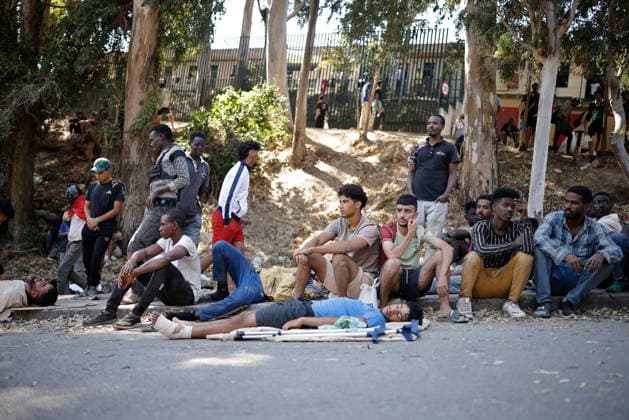 The barriers installed by the government in Ceuta are now fully operational. Several people are waiting at the gates of the Temporary Immigrant Shelter (CETI), on August 2, 2026, in Ceuta, Spain. The Tarajal border has remained calm despite a small group of people attempting to swim across; however, they were intercepted by the army. Although more than 48,000 migrants who had entered irregularly last Thursday have already left Ceuta, an unknown number of people who have refused to return remain in the city. AUGUST 2, 2026 PIXELATED MIGRATION CRISIS Jesú Ceuta, Ceuta, Spain Copyright: xJesusxTorresx 7699316