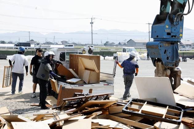 Aftermath of strong earthquake in Kumamoto A vehicle unloads waste and rubble onto a garbage-collecting site in Hikawa, Kumamoto Prefecture, southwestern Japan, on Aug. 3, 2026, after a powerful earthquake struck the region on July 28.  A14AA0005624986P