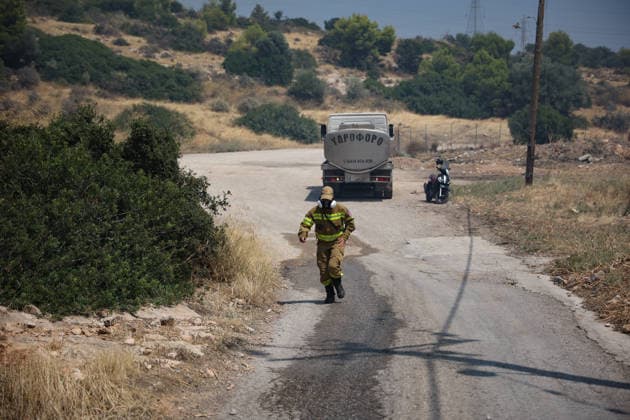 Wildfire in Greece s Megara region MEGARA, GREECE - AUGUST 3: Firefighters operate on the ground as a wildfire continues to burn for a third consecutive day in the Megara region, west of Athens, Greece on August 3, 2026. Emergency services are working to contain the blaze amid challenging weather conditions across the area. Aris Oikonomou Anadolu Megara Greece. Editorial use only. Please get in touch for any other usage.  Copyright: x2026xAnadoluxArisxOikonomoux