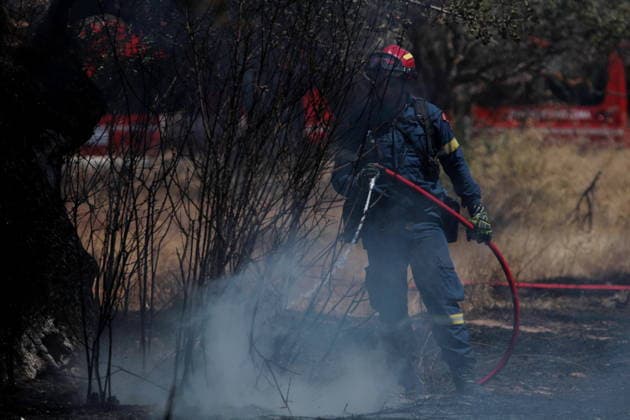 August 5, 2026, Koropi, Greece: Firefighters battle a wildfire in the Koropi area, southeast of Athens, as helicopters carry out repeated water drops to contain the flames. Ground crews worked alongside aerial firefighting units to prevent the fire from spreading amid dry conditions and strong winds. Koropi Greece  - ZUMAv62_ 20260805_zaf_v62_073 Copyright: xAristidisxVafeiadakisx