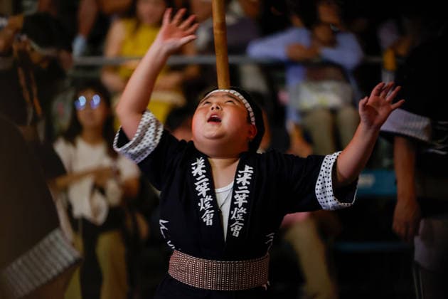August 5, 2026, Akita, Japan: A participant balances a bamboo pole adorned with paper lanterns (kanto) on his forehead during the Akita Kanto Festival in Akita City. The annual event is one of the Tohoku region s three great festivals, where street performers skillfully balance over 270 towering bamboo poles (with the largest measuring 12 meters and weighing 50 kilograms) adorned with up to 46 candle-lit paper lanterns on their hands, shoulders, and foreheads to the rhythmic chant of dokkoisho. The festival runs from August 3 to 6. Akita Japan - ZUMAm191 20260805_aap_m191_017 Copyright: xRodrigoxReyesxMarinx