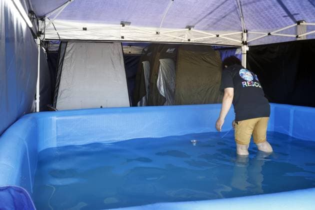 Aftermath of strong earthquake in Kumamoto Photo taken on Aug. 5, 2026, shows a temporary bath set up at a school in Hikawa in Kumamoto Prefecture, southwestern Japan, following a powerful earthquake in the region on July 28.  A14AA0005625271P