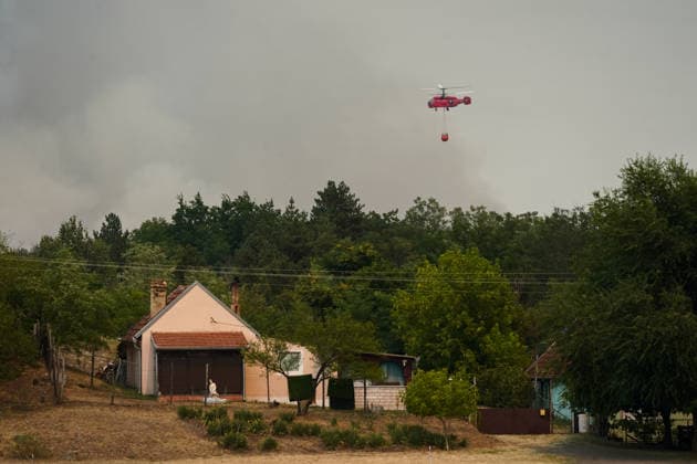 August 7, 2026, Sumarak, Vojvodina, Serbia: 202687, Sumarak, Serbia - Thick smoke rises above the landscape as a massive wildfire burns through the Deliblato Sands (Deliblatska Pescara) Special Nature Reserve. Helicopters of the Serbian Armed Forces are deployed to combat the blaze, using Bambi buckets to fetch water and extinguish the fire from the air. Deliblato Sands, often referred to as the European Sahara, is a strictly protected natural area. Sumarak Serbia  - ZUMAd223 20260807_zip_d223_004 Copyright: xMarkoxDimicx