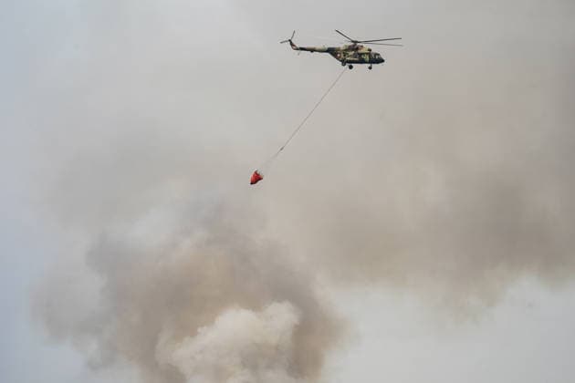 August 7, 2026, Sumarak, Vojvodina, Serbia: 202687, Sumarak, Serbia - Thick smoke rises above the landscape as a massive wildfire burns through the Deliblato Sands (Deliblatska Pescara) Special Nature Reserve. Helicopters of the Serbian Armed Forces are deployed to combat the blaze, using Bambi buckets to fetch water and extinguish the fire from the air. Deliblato Sands, often referred to as the European Sahara, is a strictly protected natural area. Sumarak Serbia  - ZUMAd223 20260807_zip_d223_007 Copyright: xMarkoxDimicx
