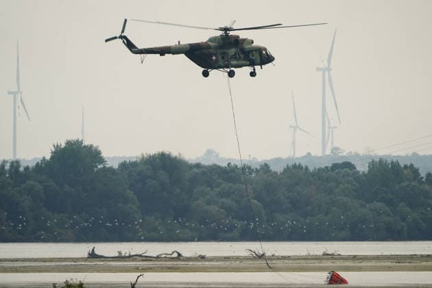 August 7, 2026, Sumarak, Vojvodina, Serbia: 202687, Sumarak, Serbia - Thick smoke rises above the landscape as a massive wildfire burns through the Deliblato Sands (Deliblatska Pescara) Special Nature Reserve. Helicopters of the Serbian Armed Forces are deployed to combat the blaze, using Bambi buckets to fetch water and extinguish the fire from the air. Deliblato Sands, often referred to as the European Sahara, is a strictly protected natural area. Sumarak Serbia - ZUMAd223 20260807_zip_d223_008 Copyright: xMarkoxDimicx